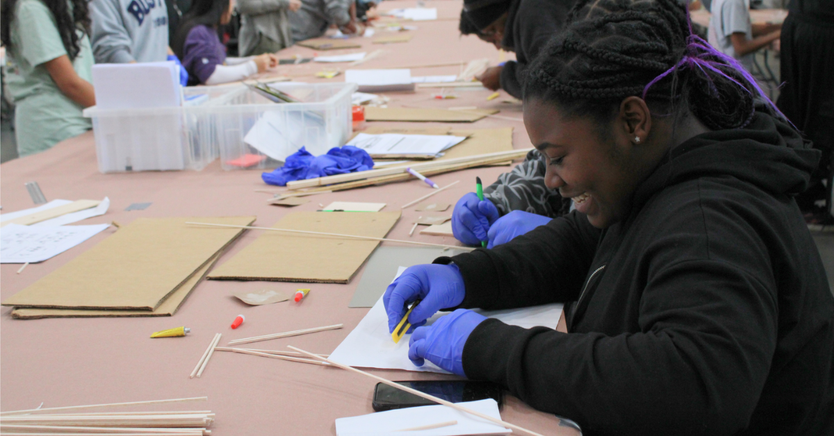 student smiling at project